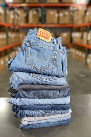 A pile of jeans sitting on top of each other.