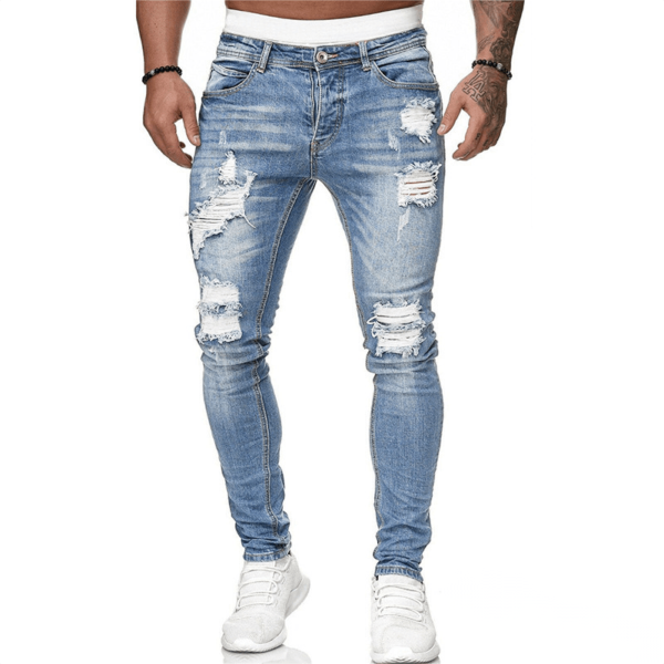 A man wearing ripped jeans and white sneakers.